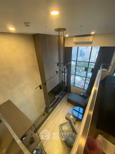 Stunning loft apartment with high ceilings and city view, featuring modern living area and large windows.
