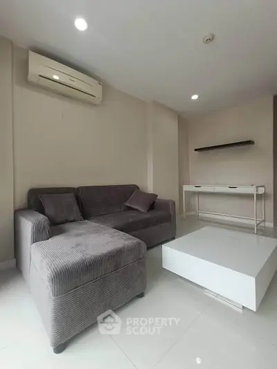 Modern living room with sleek furniture and air conditioning, perfect for comfortable living.