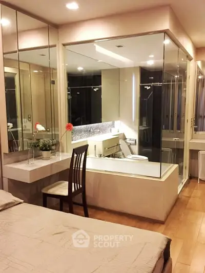 Luxurious bedroom with glass-enclosed bathroom and elegant decor