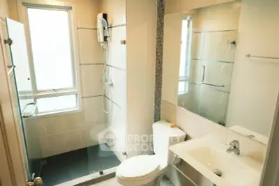 Modern bathroom with glass shower and sleek fixtures in a bright, well-lit space.