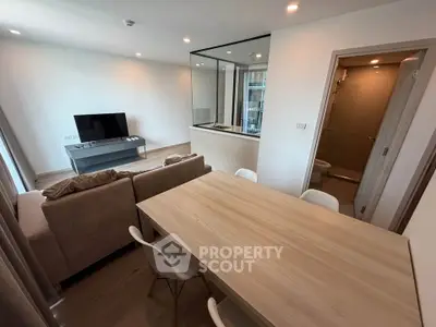 Modern open-plan living room with dining area and sleek kitchen design