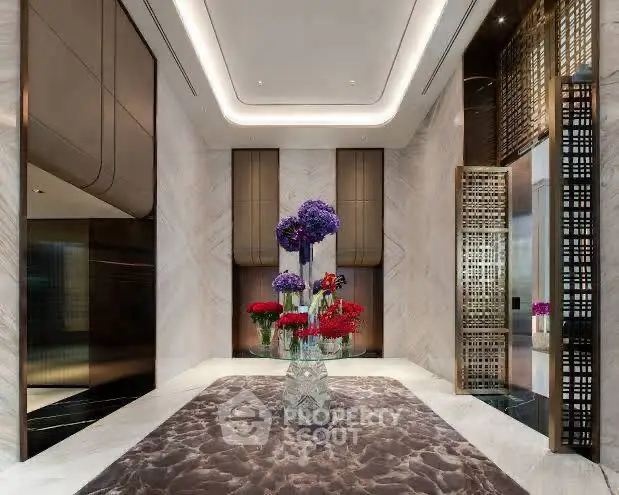 Luxurious building entrance with elegant floral arrangement and modern design.