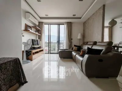 Spacious living room with modern decor and balcony view