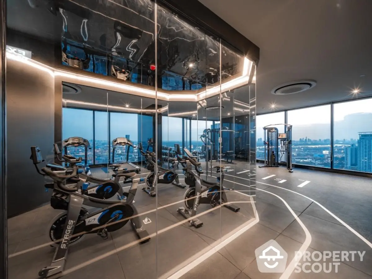 Luxury high-rise gym with panoramic city views and modern fitness equipment.