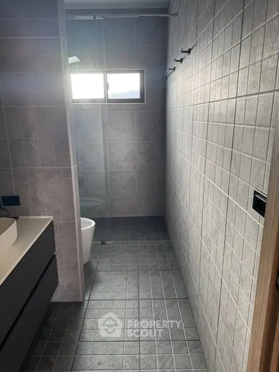 Modern bathroom with sleek tiles and glass shower enclosure