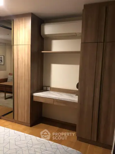 Modern bedroom with built-in wooden wardrobe and air conditioning unit