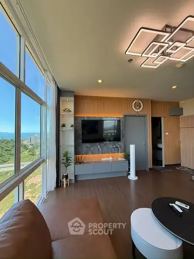 Modern living room with large windows offering stunning views and stylish decor.