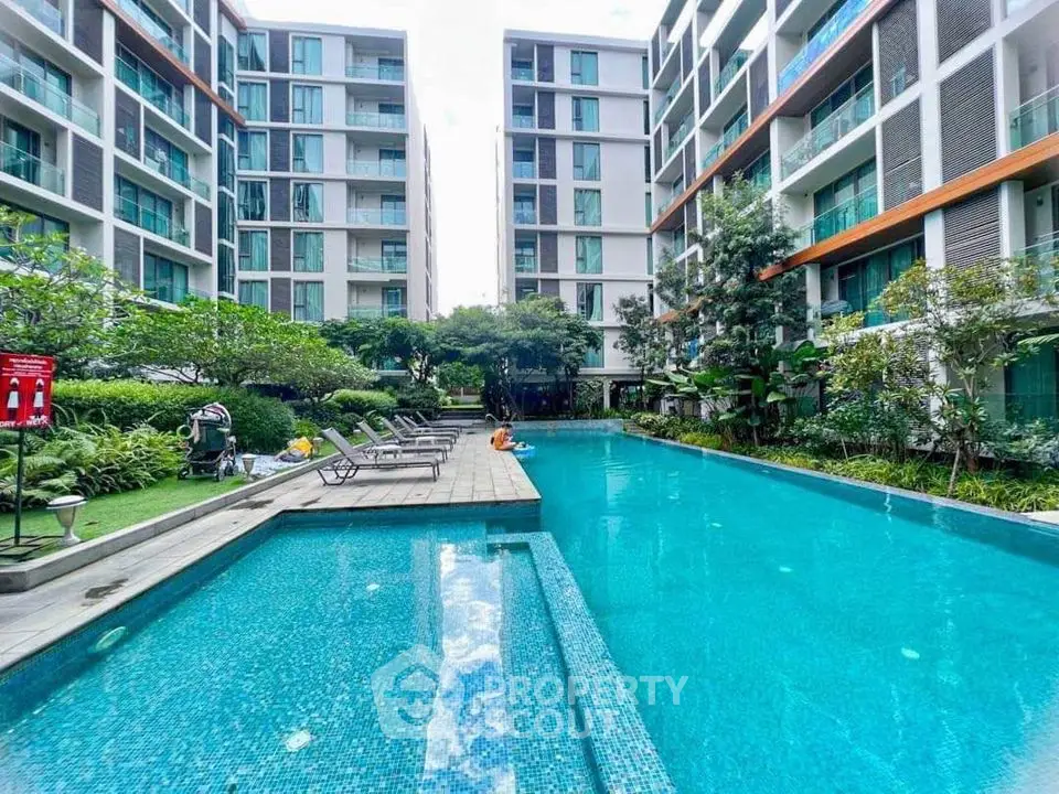 Luxurious condominium with a stunning outdoor pool and lush garden view.