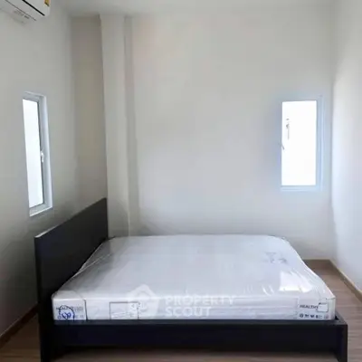 Minimalist bedroom with natural light and modern bed setup