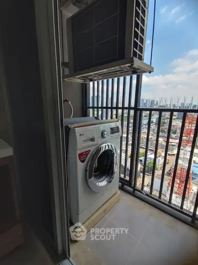 High-rise balcony with washing machine and city view, perfect for urban living convenience.