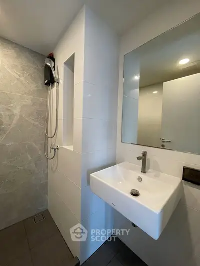 Modern bathroom with sleek sink and shower area in contemporary design