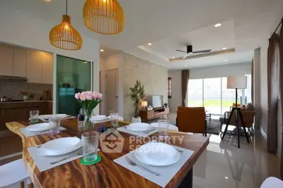 Modern open-plan living and dining area with stylish decor and natural light.