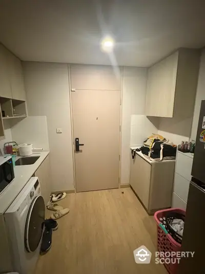 Compact kitchen with washing machine and modern cabinetry