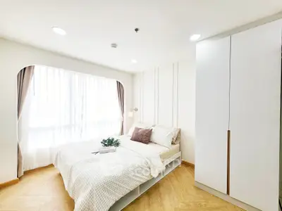 Bright and modern bedroom with elegant decor and ample natural light.
