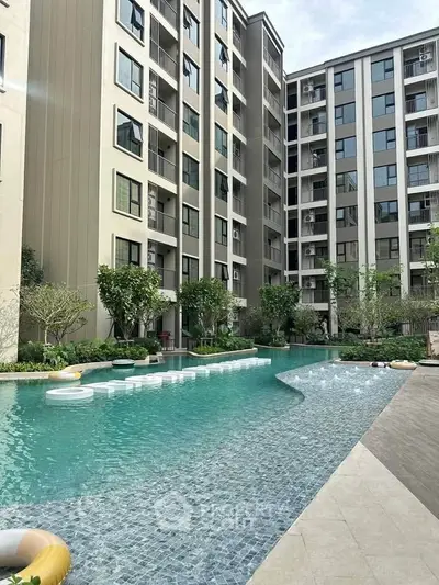 Modern apartment complex with luxurious pool and lush greenery, perfect for urban living.