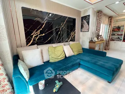 Luxurious living room with elegant teal sofa and marble accent wall