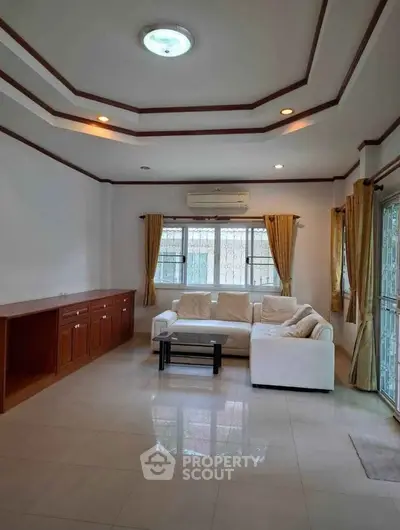 Spacious living room with elegant ceiling design and cozy seating area.