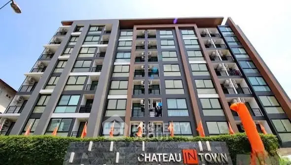 Modern urban condominium building with sleek design and large windows, ideal for city living.