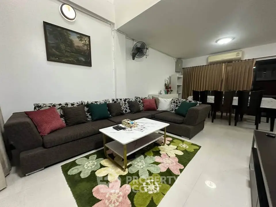 Spacious living room with stylish decor and comfortable seating in modern home.