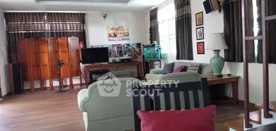 Spacious living room with elegant decor and natural light, featuring comfortable seating and stylish furnishings.