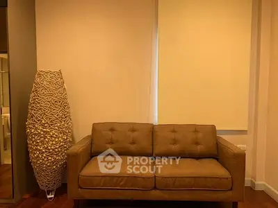 Cozy living room with stylish sofa and unique floor lamp, perfect for modern interiors.