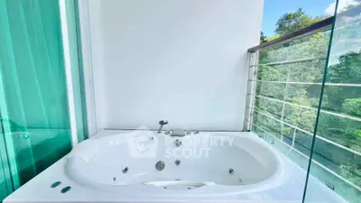 Luxurious balcony with a private jacuzzi and scenic view, perfect for relaxation.