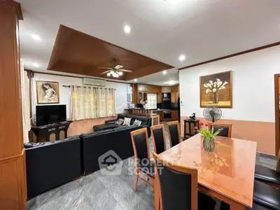 Spacious open-plan living and dining area with modern furnishings and elegant decor.