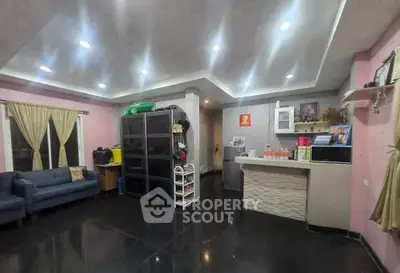 Spacious living room with modern lighting and cozy seating area, perfect for family gatherings.