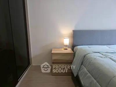 Cozy bedroom with modern decor and soft lighting, featuring a stylish bed and sleek wardrobe.