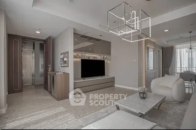 Modern living room with sleek design and elegant furniture, featuring a large TV and stylish lighting fixtures.