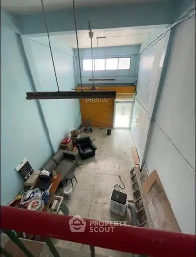 Spacious loft-style living area with high ceilings and modern furnishings.