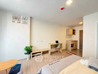 Modern studio apartment with cozy living area and compact kitchen