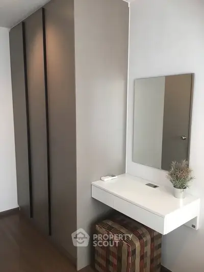Modern bedroom with sleek wardrobe and stylish vanity area