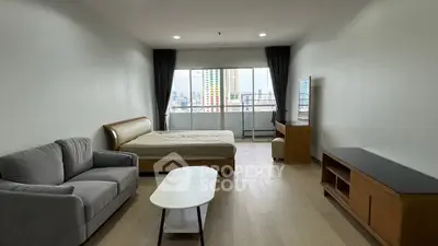 Spacious studio apartment with modern furnishings and city view balcony