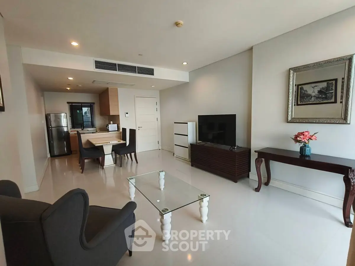 Spacious modern living room with elegant furniture and open kitchen layout