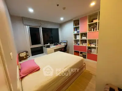 Cozy bedroom with built-in shelves and study desk, perfect for modern living.