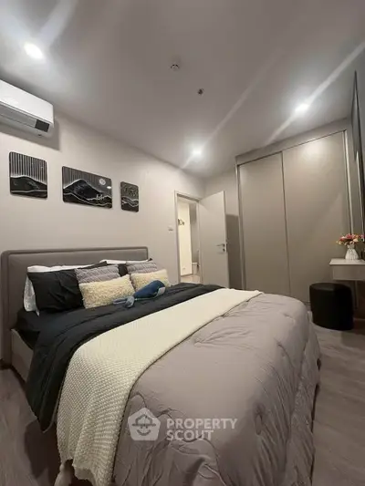 Modern bedroom with stylish decor and cozy ambiance, featuring a comfortable bed and sleek wardrobe.