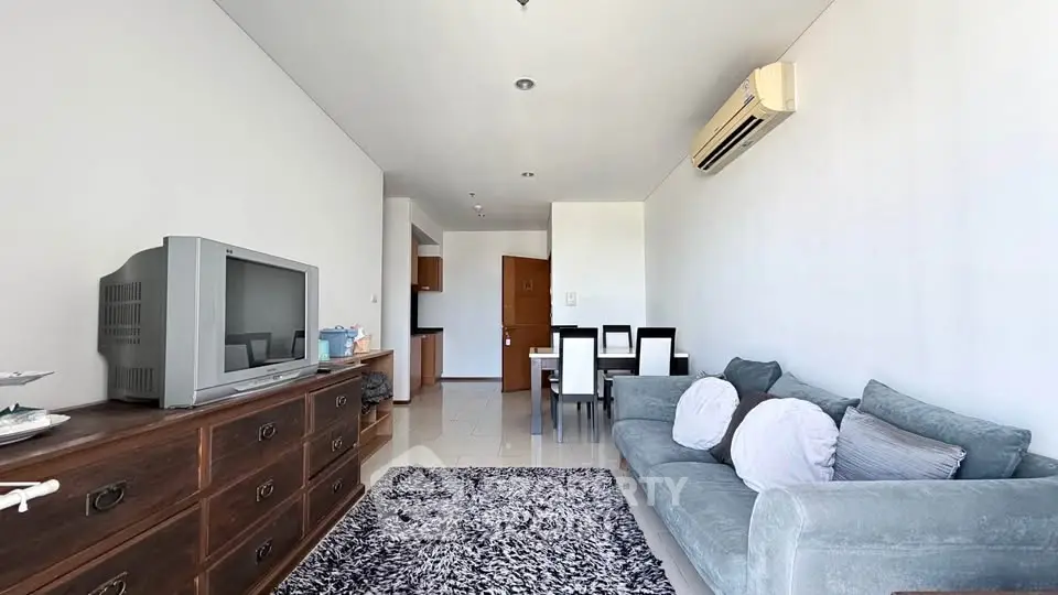 Spacious living room with modern decor and air conditioning in a stylish apartment.
