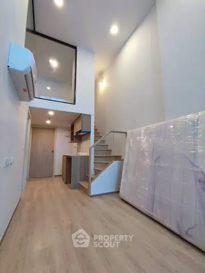 Modern loft apartment with high ceiling and wooden staircase