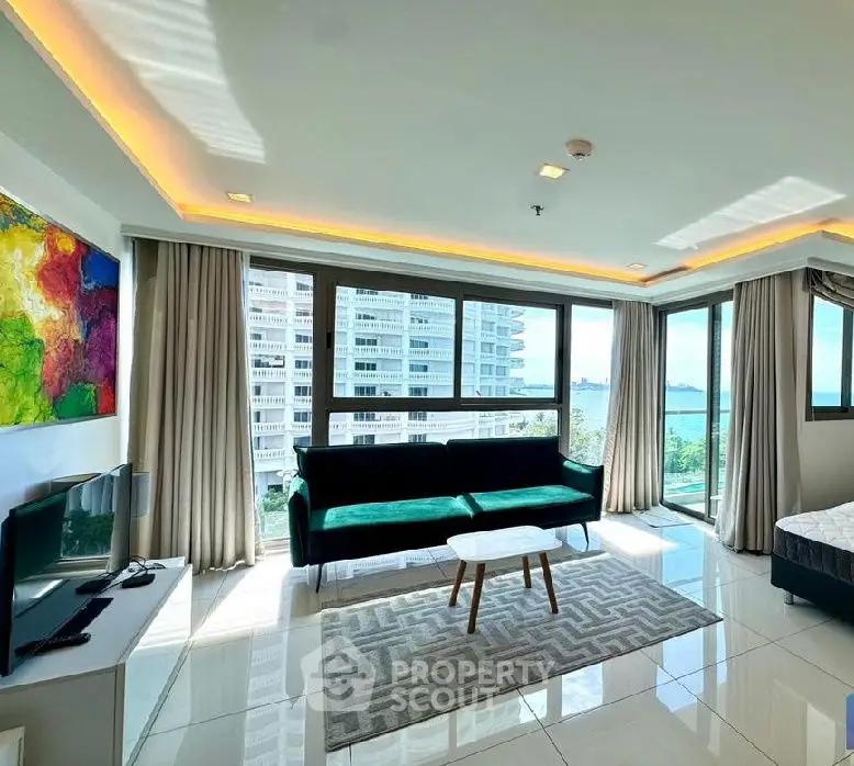 Spacious living room with modern decor and stunning city view.
