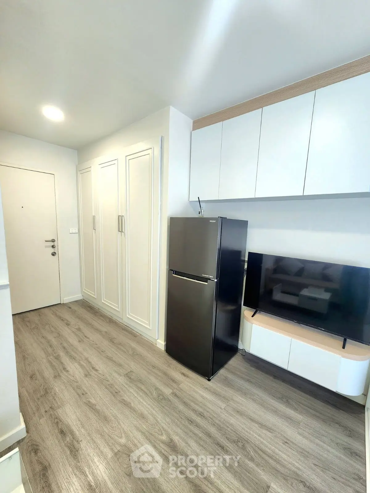 Modern apartment interior with sleek kitchen and stylish storage solutions.