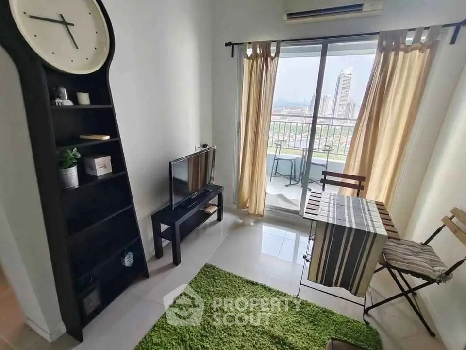 Cozy living room with balcony view, modern decor, and natural light.