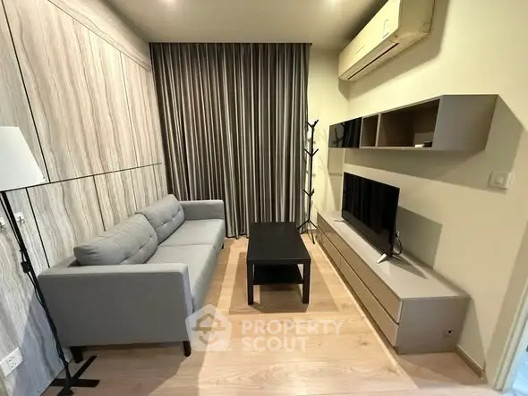 Modern living room with sleek furniture and air conditioning unit