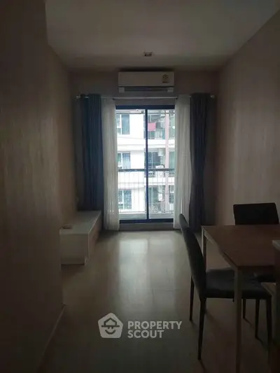 Modern apartment interior with dining area and large window view.