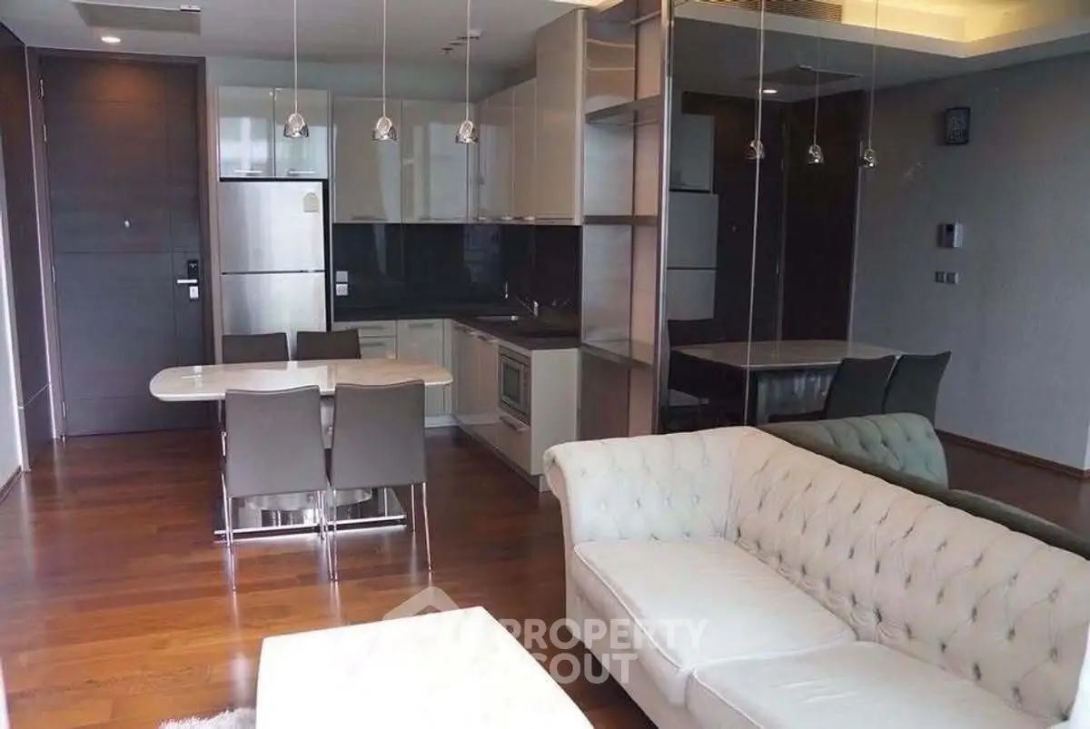 Modern open-plan living room with sleek kitchen and elegant dining area