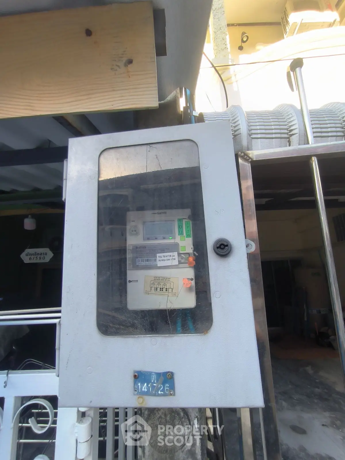 Exterior view of a building's electrical meter box, showcasing utility infrastructure.
