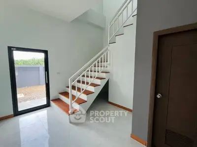 Modern interior with sleek staircase and natural light, perfect for contemporary living.