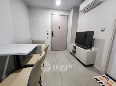 Modern living room with sleek furniture and air conditioning unit