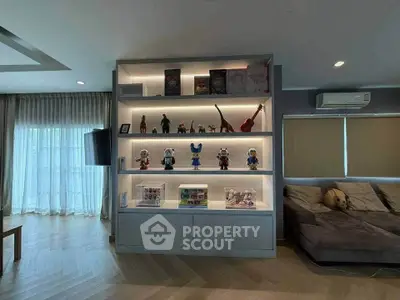 Modern living room with stylish display shelf and cozy seating area.