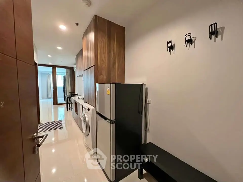 Modern kitchen with sleek appliances and stylish decor in a contemporary apartment.